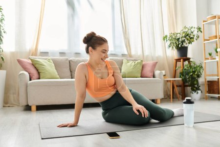 Middle-aged woman peacefully sits on yoga mat in relaxed home setting.