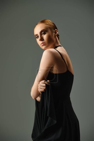 Téléchargez les photos : A young ballerina in a sleek black dress strikes a pose for a photograph. - en image libre de droit