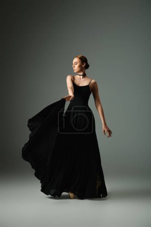 Téléchargez les photos : A young woman in a black dress striking a pose. - en image libre de droit
