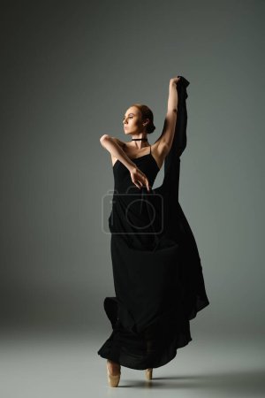 Young ballerina in black dress dances with grace and passion.
