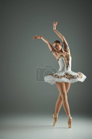 A talented young ballerina in a white tutu striking a pose.
