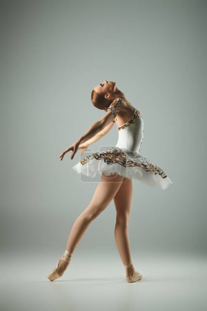 Young ballerina dances gracefully in white tutu and leotard.