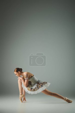 Photo for A graceful ballerina poses in a white dress. - Royalty Free Image