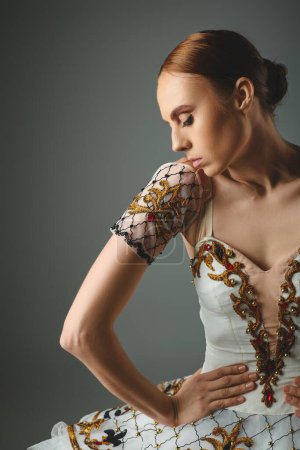 Téléchargez les photos : A young, beautiful, talented ballerina dances energetically in a stunning white and gold dress. - en image libre de droit