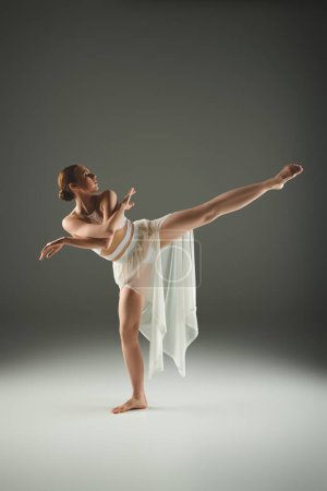 Young ballerina in white dress exhibits grace and energy in a dynamic dance pose.