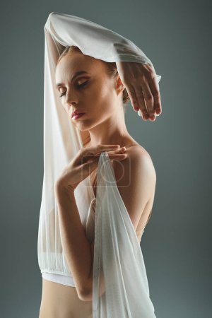 Young ballerina exudes grace and mystery in a veiled performance.