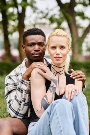 Photo for Multicultural couple, African American man and Caucasian woman in a park. - Royalty Free Image