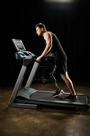 A man with a prosthetic leg runs on a treadmill in a dimly lit room, showing determination and strength in his workout.