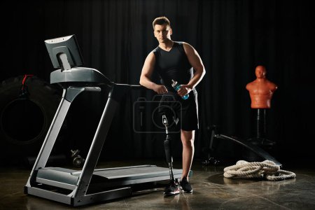 A disabled man with a prosthetic leg stands on a treadmill in a dark room, focused on his workout routine.