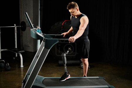 A disabled man with a prosthetic leg uses a treadmill in a dimly lit room, focused on his workout routine.