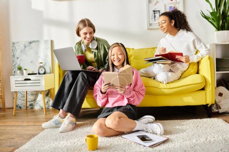 A diverse group of teenage girls sit closely together on a vibrant yellow couch, engrossed in studying and deep in conversation.