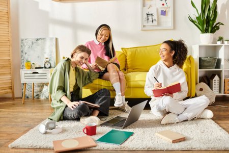A group of teenage girls of different ethnicities sitting together on a yellow couch, studying and enjoying each others company.