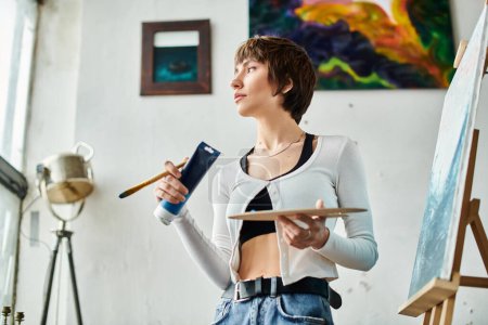 Woman with a paintbrush in each hand, showcasing her artistic skills with style.