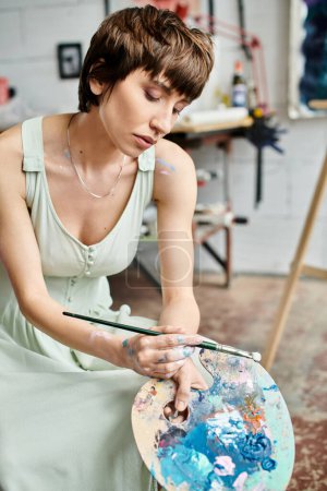A woman wearing a dress is painting a picture.