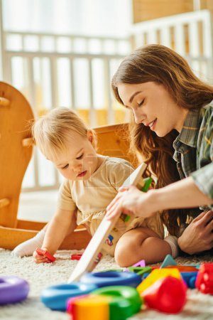 A young mother and her toddler daughter enjoy quality time together, playing with toys on the floor in a cozy home setting.