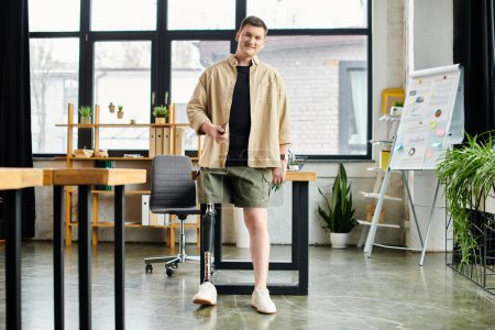 Handsome businessman with prosthetic leg stands before desk in modern office.