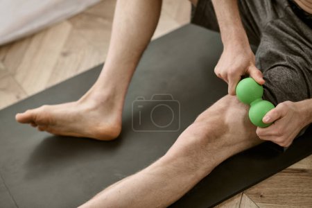 Photo for Handsome man practices yoga poses on mat at home. - Royalty Free Image