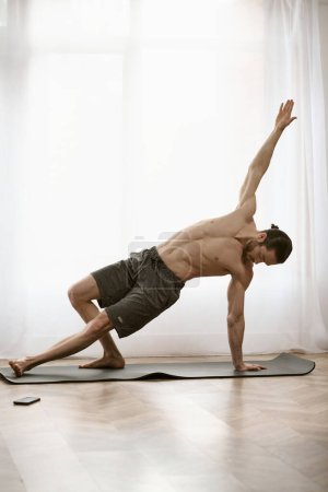 A handsome man finds tranquility on his yoga mat as he practices a posture.