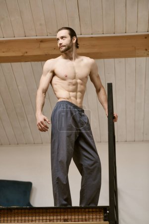 Shirtless man confidently posing at home.