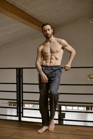 A shirtless man stands on a wooden floor, engaging in his morning routine.
