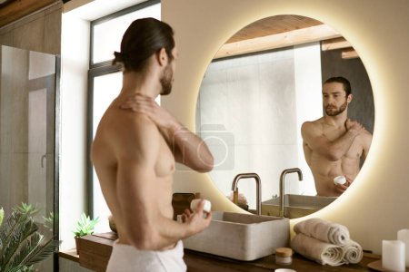 Handsome man skincare routine in bathroom mirror.