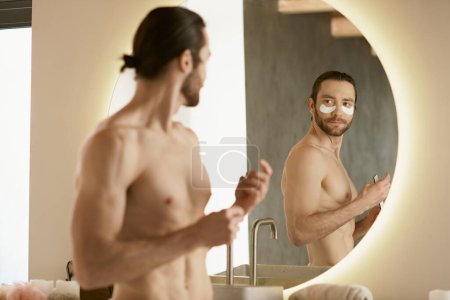 Shirtless man scrutinizes self in mirror during morning routine.