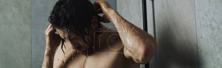 Photo for A man taking a shower during his morning routine. - Royalty Free Image