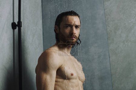 Shirtless man in shower at home.
