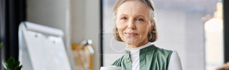 Businesswoman in office setting, with cup of coffee.