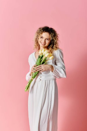 Photo for Woman in white dress holding tulip bouquet. - Royalty Free Image