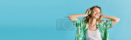 Curly-haired woman in green Hawaiian shirt exudes elegance against a blue backdrop.