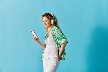 A woman with headphones on, enjoying music on her phone.