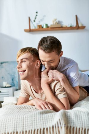 Photo for Two men in casual attire lie together on a bed, sharing a tender moment. - Royalty Free Image