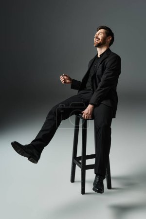 A man in elegant attire sits atop a stool.