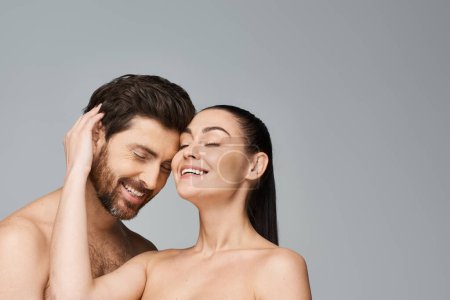 Photo for Shirtless man and pretty woman pose together. - Royalty Free Image