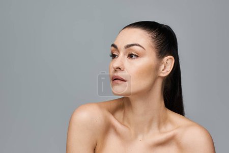 Photo for A woman with very long hair stands on white backdrop. - Royalty Free Image