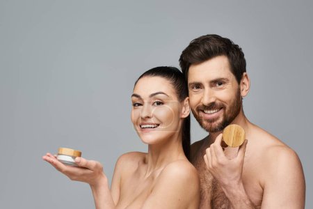A stylish couple poses together in a skincare promotion.