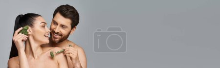 Photo for Cheerful couple, radiating beauty, using face roller and gua sha together. - Royalty Free Image