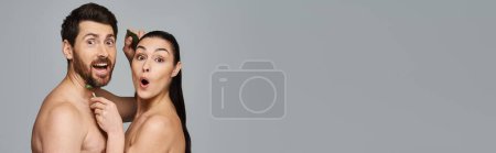 Photo for An attractive couple posing together, applying skincare. - Royalty Free Image