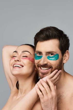 A man and a woman both wearing eye patches posing together.