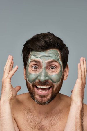 Man with a facial mask on white backdrop.