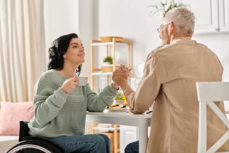 In a cozy kitchen at home, a woman in a wheelchair holding hands with husband