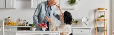 Photo for Happy brunette woman hugging her husband while receiving present from him, banner - Royalty Free Image