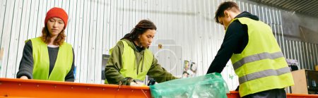 Photo for Young volunteers in gloves and safety vests sort trash, showing eco-conscious efforts to make a difference. - Royalty Free Image
