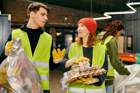 Photo for Eco-conscious people, in gloves and safety vests, stand together, sorting trash as young volunteers. - Royalty Free Image