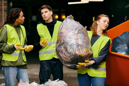 Young volunteers in gloves and safety vests stand together, sorting trash in a united effort towards sustainability.