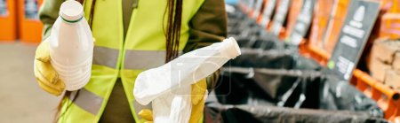 A young woman in a yellow safety vest participating in a trash sorting initiative