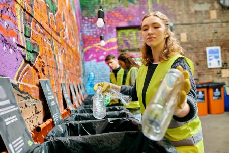 Téléchargez les photos : A woman standing beside a vibrant graffiti-covered wall, expressing urban creativity and culture. - en image libre de droit