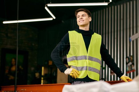 Photo for A young volunteer in safety vest and gloves sorts waste, showing eco-consciousness and dedication. - Royalty Free Image