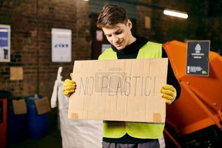 Téléchargez les photos : Young volunteer in gloves and safety vest promotes eco-friendly habits by advocating against plastic use. - en image libre de droit